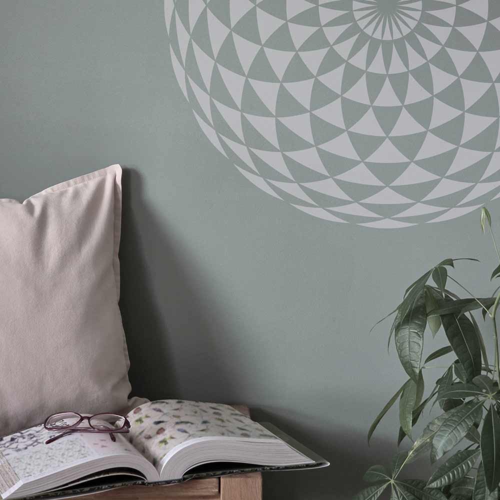 Torus auf Wand schabloniert. Darunter ist eine Sitzbank mit Kissen und Buch.
